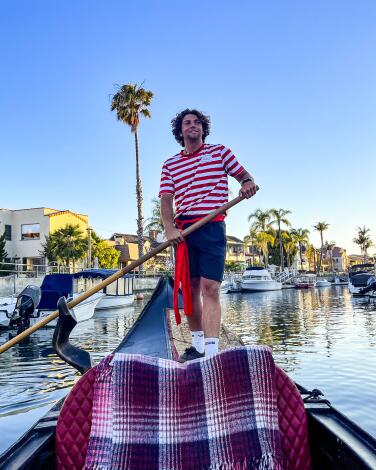 A gondolier propels a boat through the canals of Naples in Long Beach.