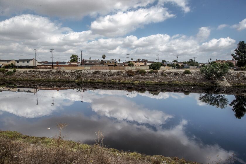 CARSON, CA - OCTOBER 11, 2021: Overall, shows the Dominguez Channel in Carson as seen from near Carson St. A foul odor is emanating from the Dominguez Channel and public health officials are recommending Carson residents keep their doors and windows closed as authorities work to address the odor. The Dominguez Channel is a drain channel that crosses through industrial areas on its way to the Port of Los Angeles. (Mel Melcon / Los Angeles Times)