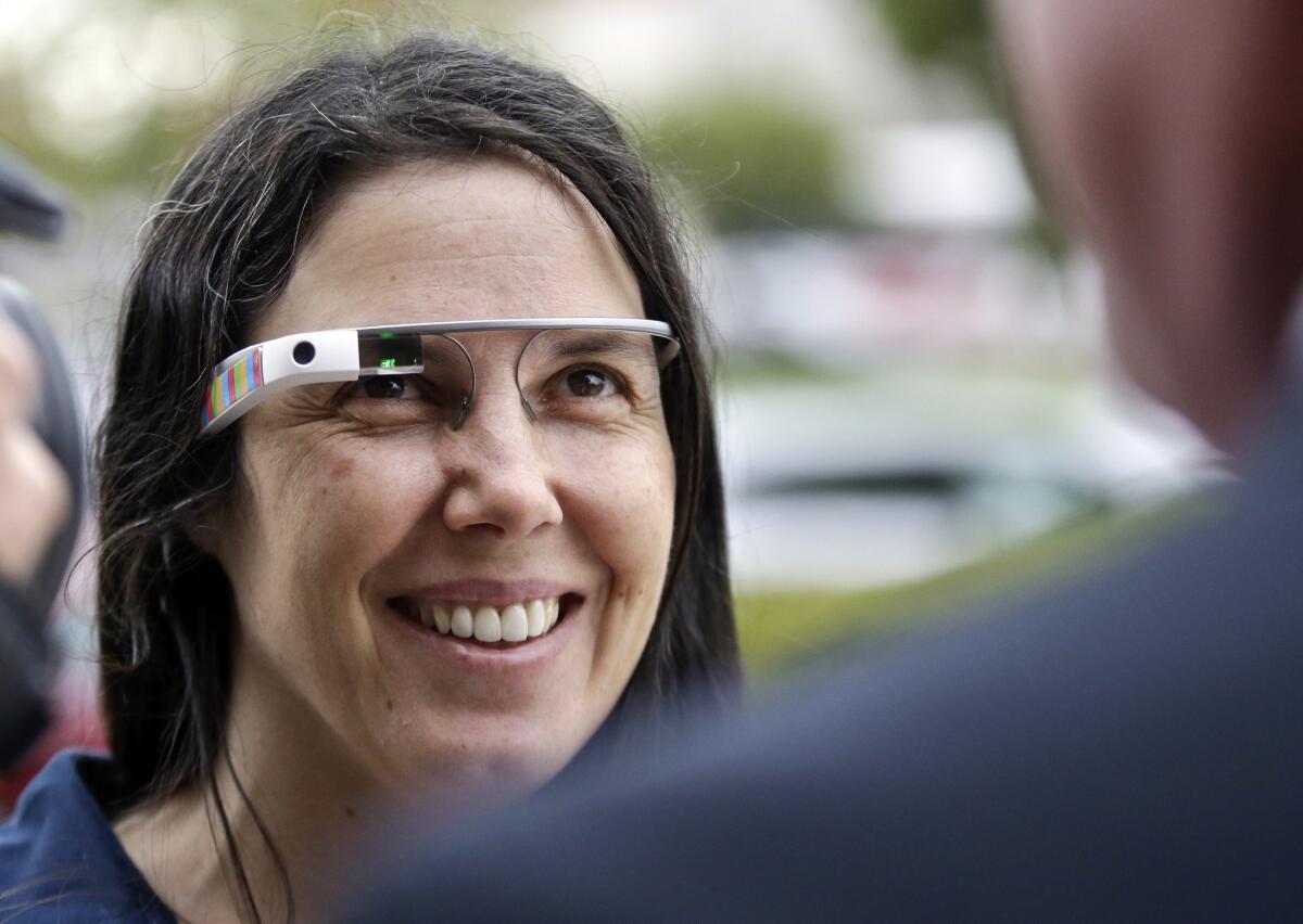 Cecilia Abadie wears her Google Glass as she talks with her attorney outside San Diego traffic court. Abadie pleaded not guilty to speeding and distracted driving for wearing the Google Glass.