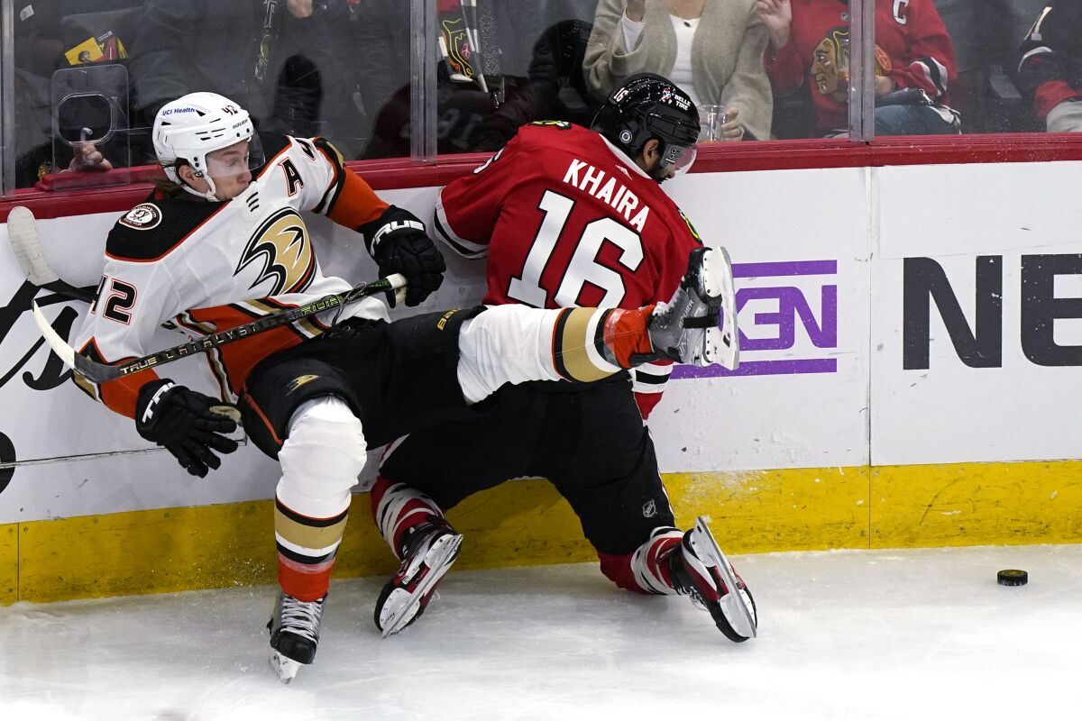 Ducks defenseman Josh Manson, left, and Blackhawks left wing Jujhar Khaira battle Jan. 15, 2022.