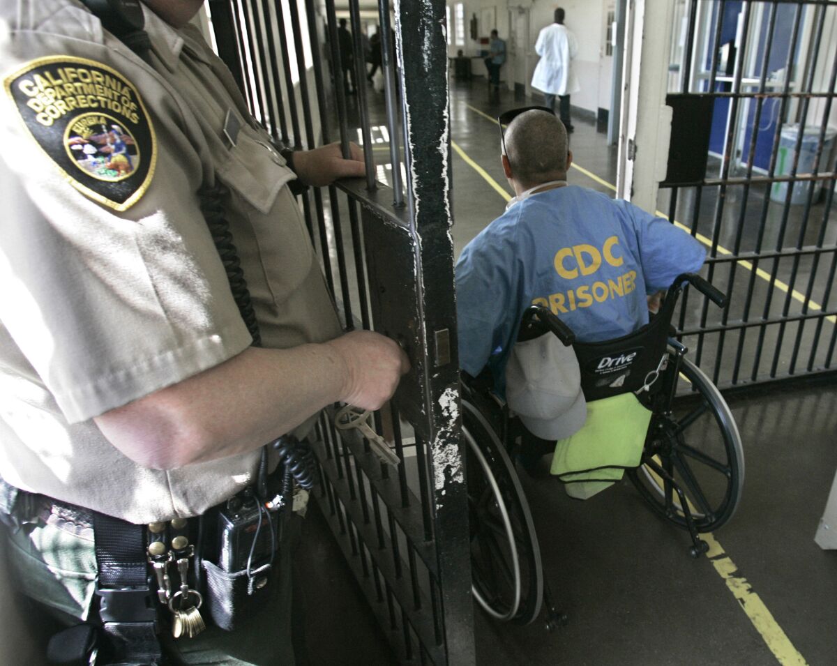 An inmate in a wheelchair wheels himself through a checkpoint at the California Medical Facility in Vacaville, Calif.