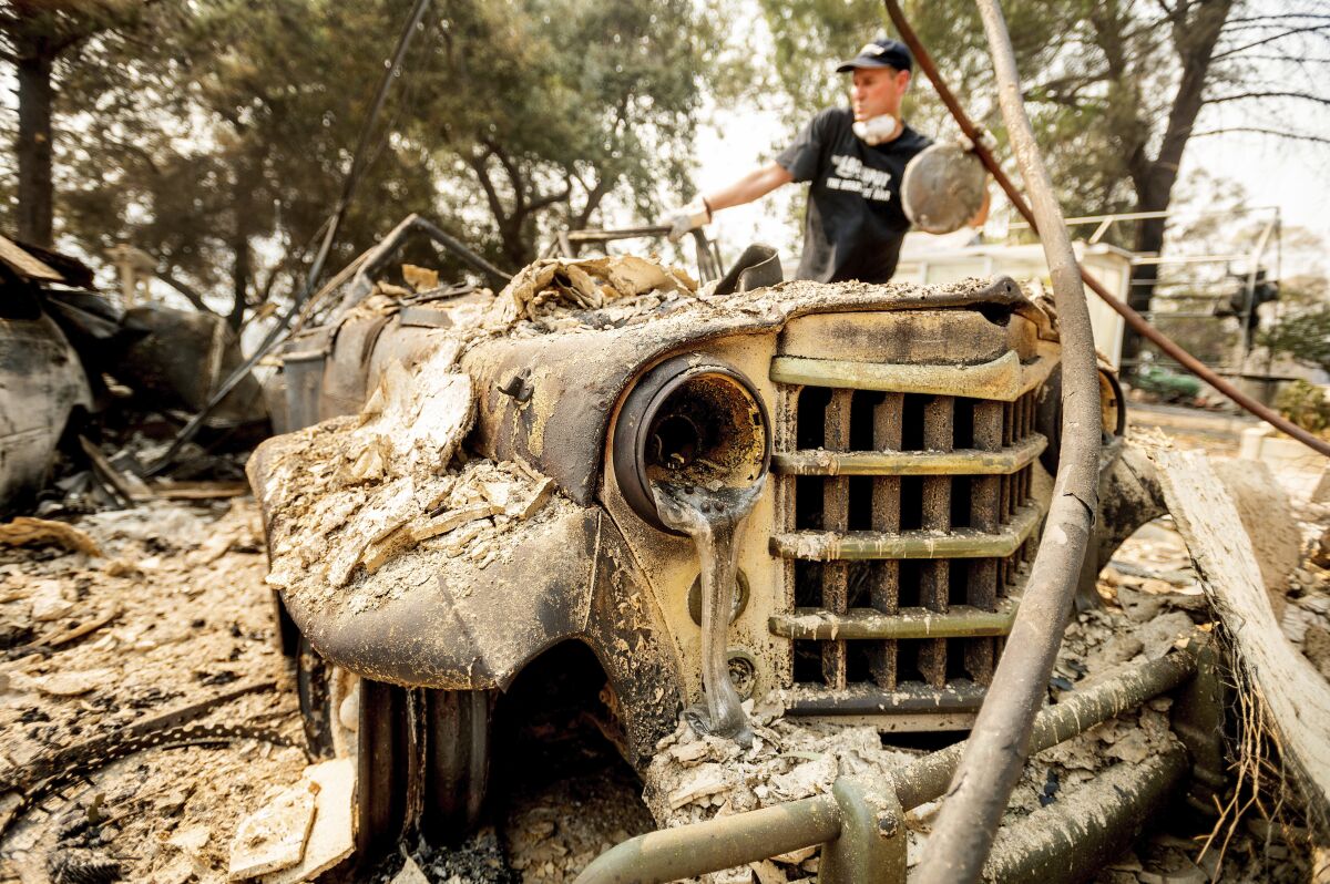 Mark Hanson goes through the remains of a 1951 Willys-Overland Jeepster 