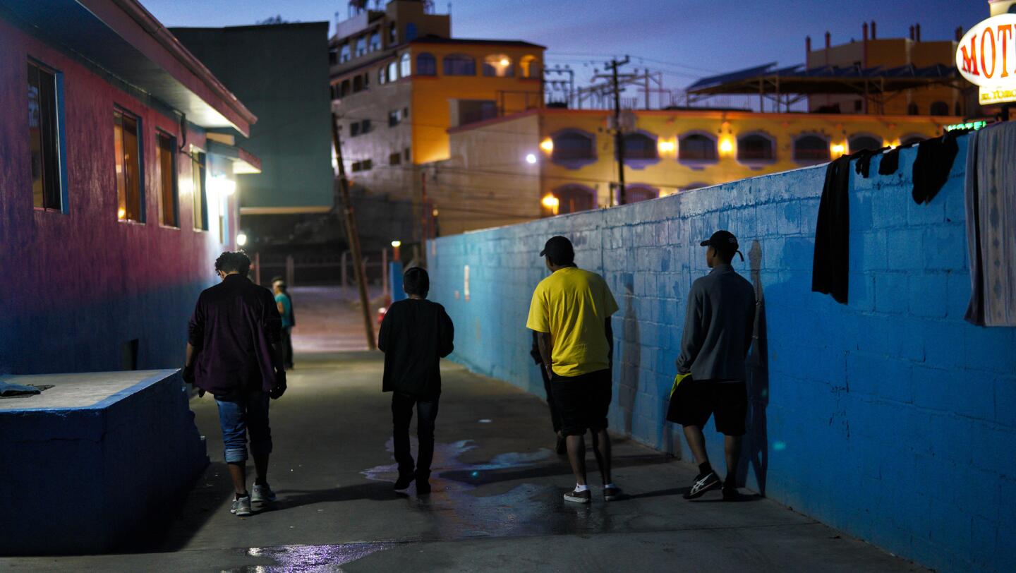 Teenage boys hangout in the driveway of the Casa YMCA in Tijuana where they have been sheltered. The boys traveled unaccompanied with the migrant caravan traveling from Central America.