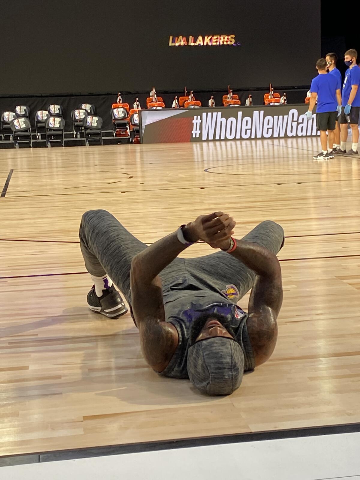 Lakers star LeBron James, while wearing his MagicBand, stretches before a game in the NBA bubble in Orlando.