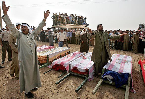 Syrian villagers shout anti-U.S. slogans as they gather near relatives' coffins.