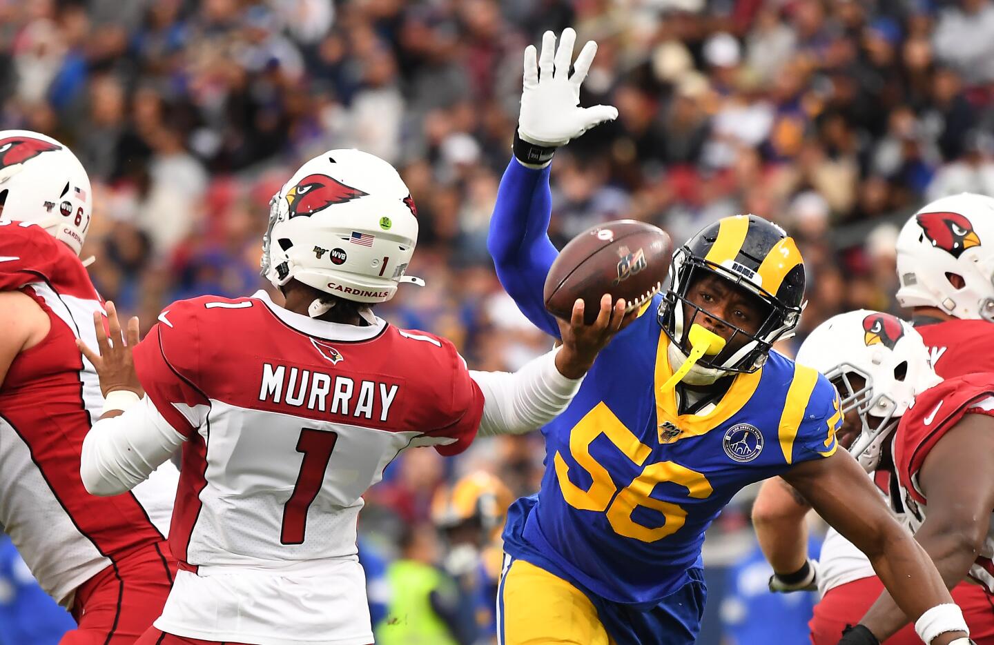 Rams linebacker Dante Fowler Jr. tries to knock the ball away from Arizona Cardinals quarterback Kyler Murray.