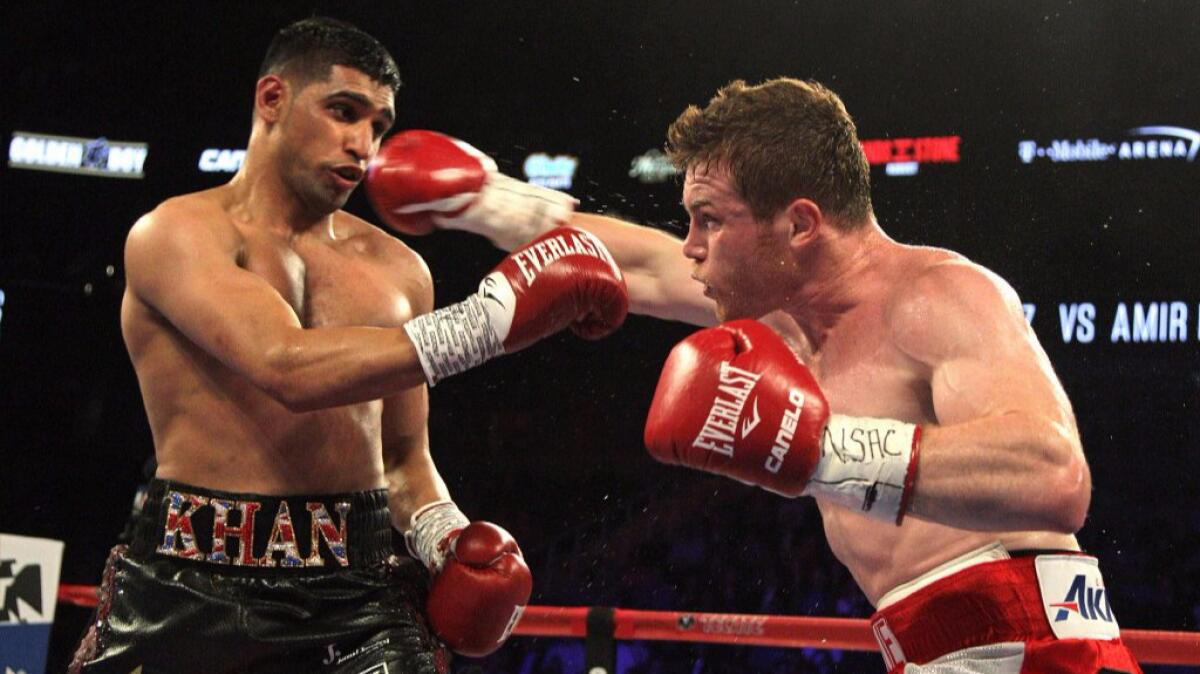 Canelo Alvarez throws a right hand at Amir Khan during their middleweight title bout in Las Vegas on May 7.