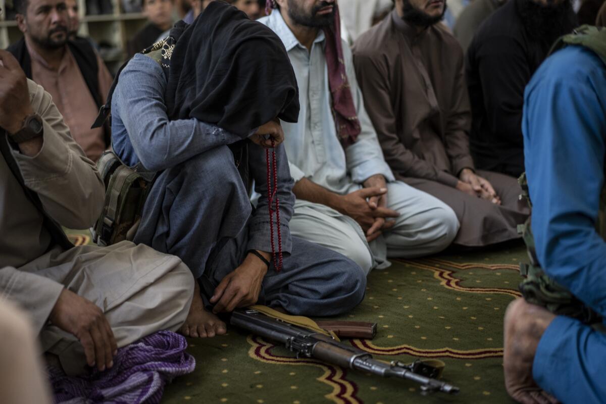 A member of the Taliban prays inside a mosque in Kabul, Afghanistan, on Friday.