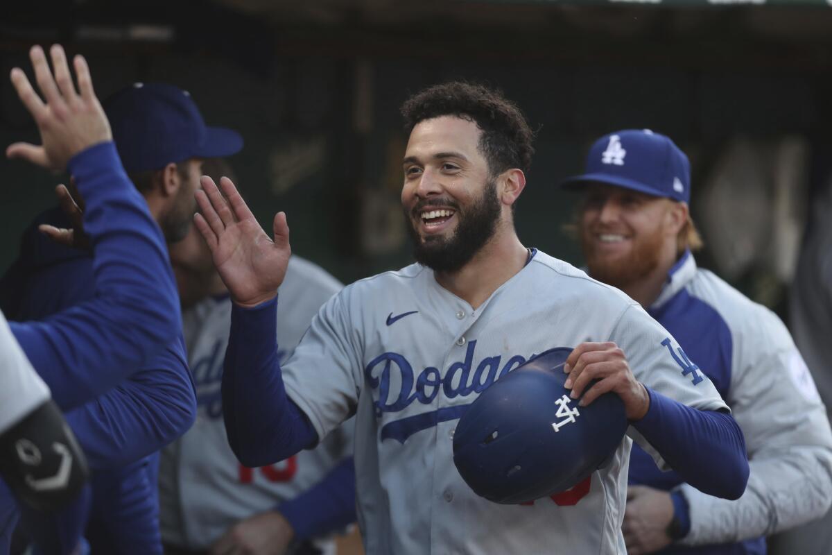Los Angeles Dodgers' Edwin Rios is congratulated by teammates after hitting a home run.