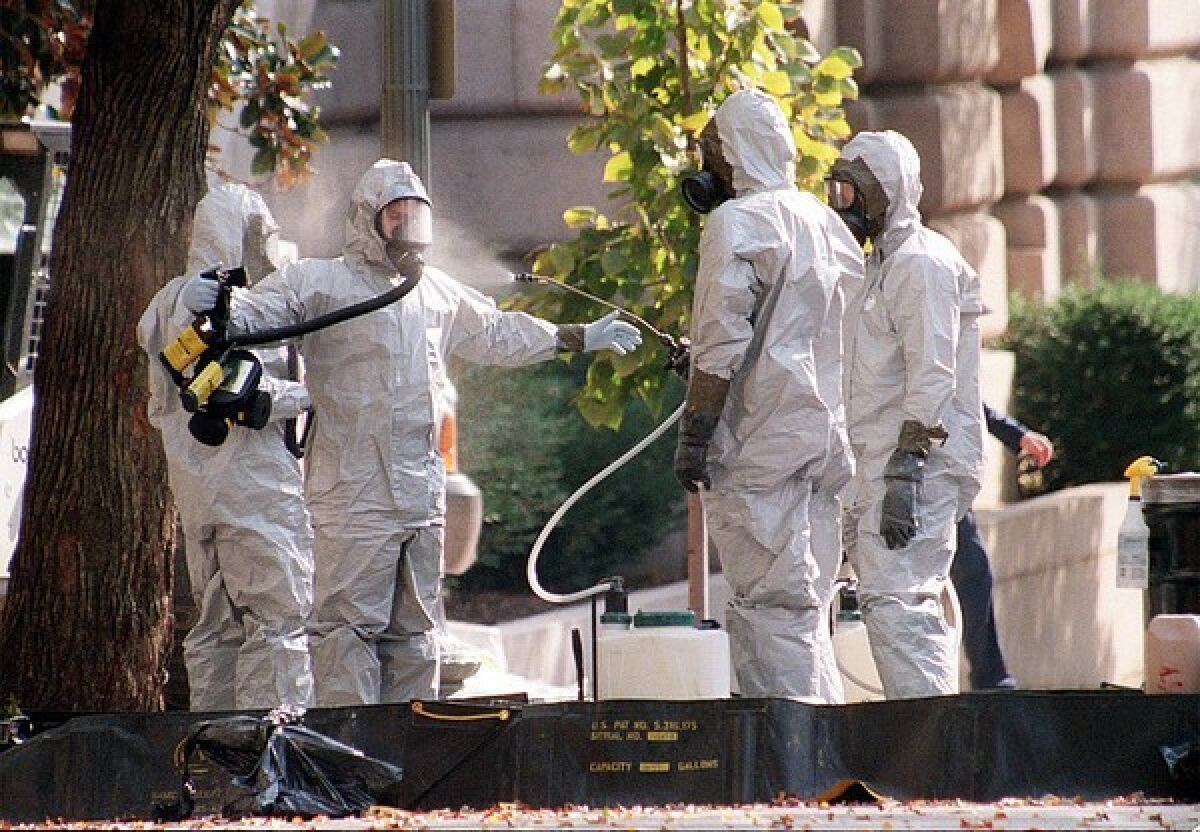 A hazmat worker is hosed off on Capitol Hill in October 2001 after anthrax-laced letters were sent to two senators. 