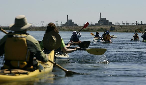 Kayakers on a Columbia River tour take in the view of the B reactor at the Hanford nuclear site just north of Richland in southeast Washington state. The "B" plant produced the world's first weapons-grade plutonium for the nuclear bomb dropped on Nagasaki, Japan, in World War II. In 2000, then-President Clinton proclaimed 195,000 acres along the river and around the nuclear site a national monument.