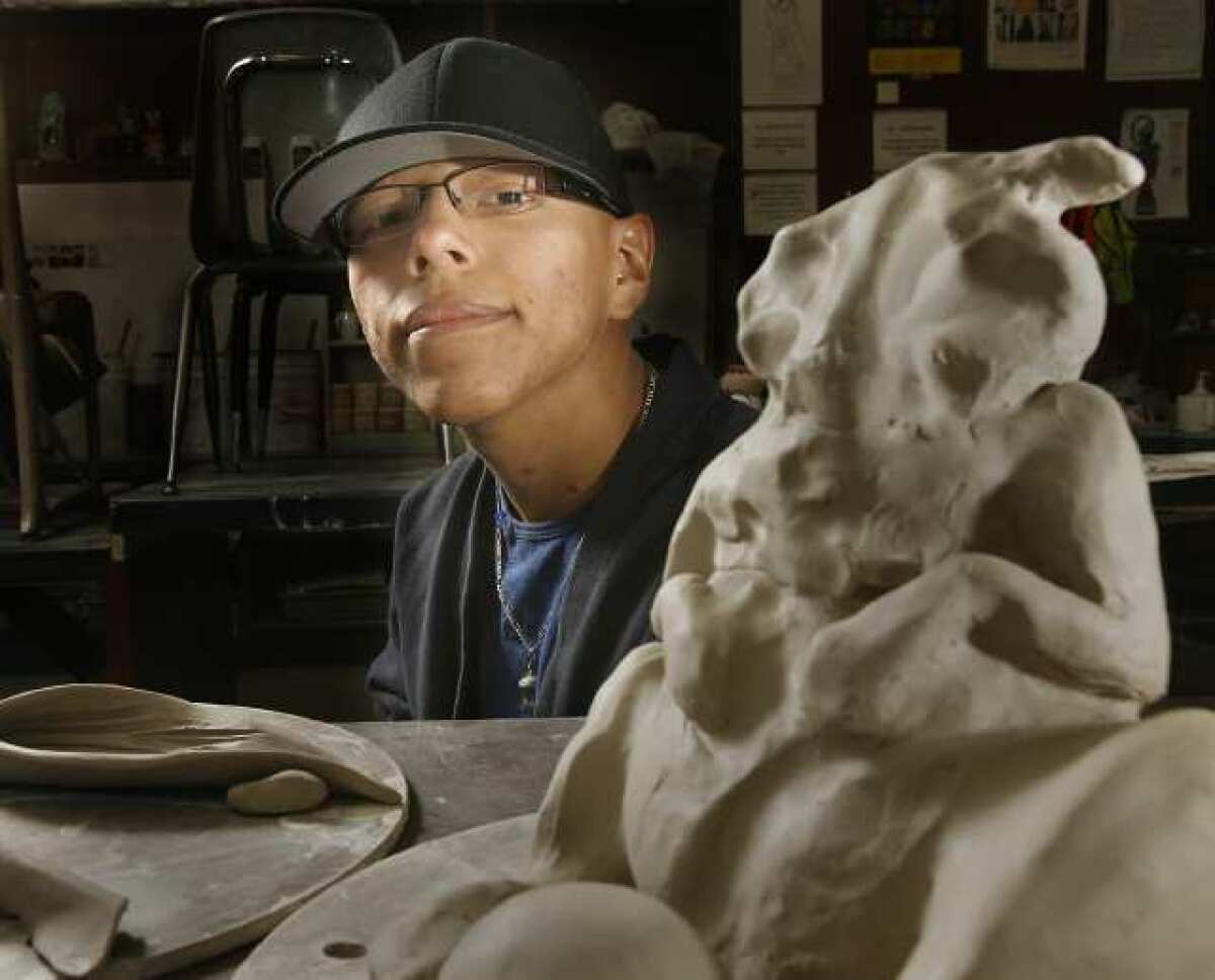 Bryant Santamaria, of Hoover HIgh School, in his art class with an art project that he is working on. Santamaria will have a mask he created on display at an art show next week, and he has been accepted to several art schools across the country. He is the first in his family to attend college.
