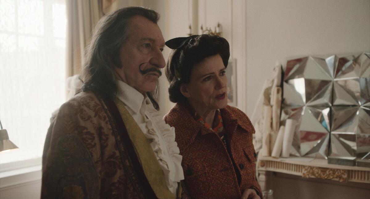 a man with a mustache, left, and a woman