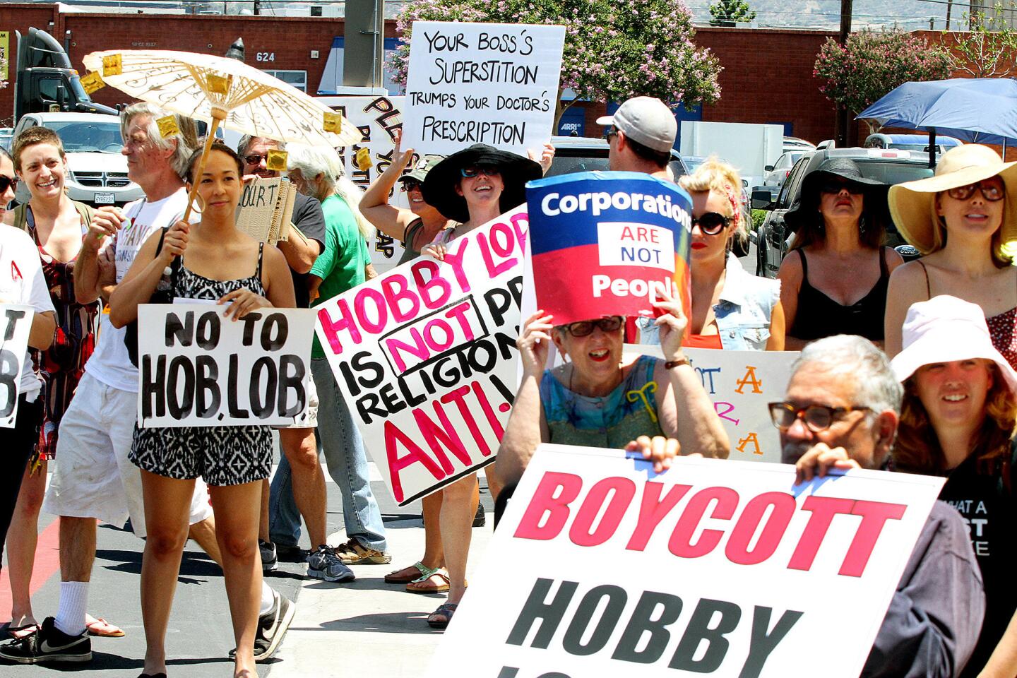 Protesters at a protest, of mostly women, in front of the newly opened Hobby Lobby in Burbank on Monday, July 7, 2014. The protesters have taken issue with a lawsuit filed by Hobby Lobby for the right to strike some of the contraceptive options available through Obamacare that conflicts with the companies religious philosophy, a lawsuit that escalated to the Supreme Court of the United States who sided with Hobby Lobby.