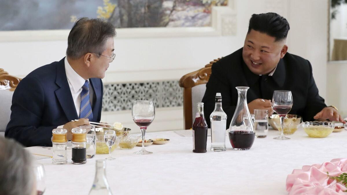 North Korean leader Kim Jong Un (right) and South Korean President Moon Jae-in talk during lunch at the Okryukwan cold noodle restaurant in Pyongyang on Sept. 19, 2018.