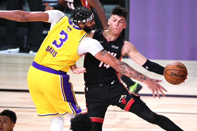 ORLANDO, FLORIDA SEPTEMBER 30, 2020-Lakers Anthoiny Davis forces Heat's Tyler Herro.