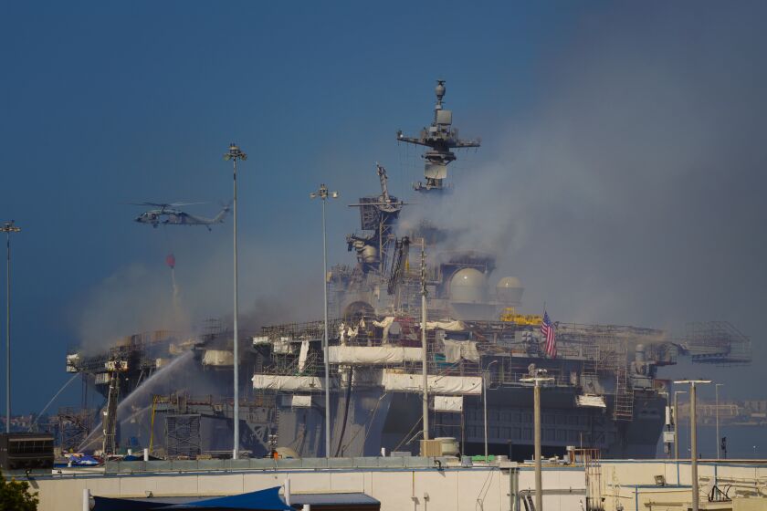Navy used helicopters for water drops over the fire that continues to burn aboard Bonhomme Richard at San Diego  on Monday.