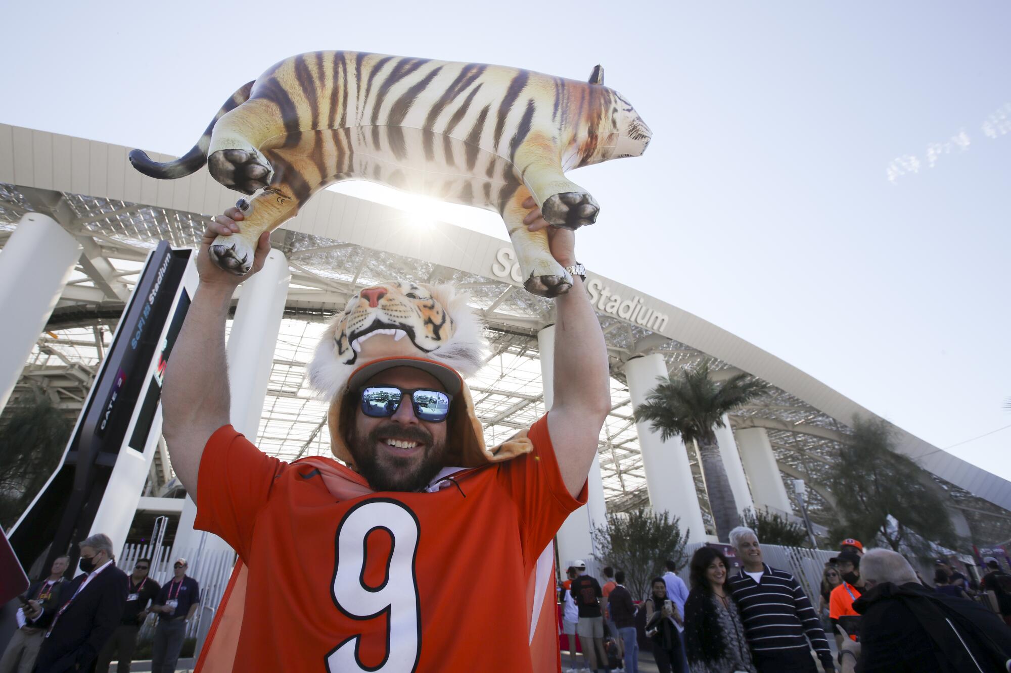 A Bengals fan holds up an inflated tiger outside of SoFi Stadium before Super Bowl LVI.