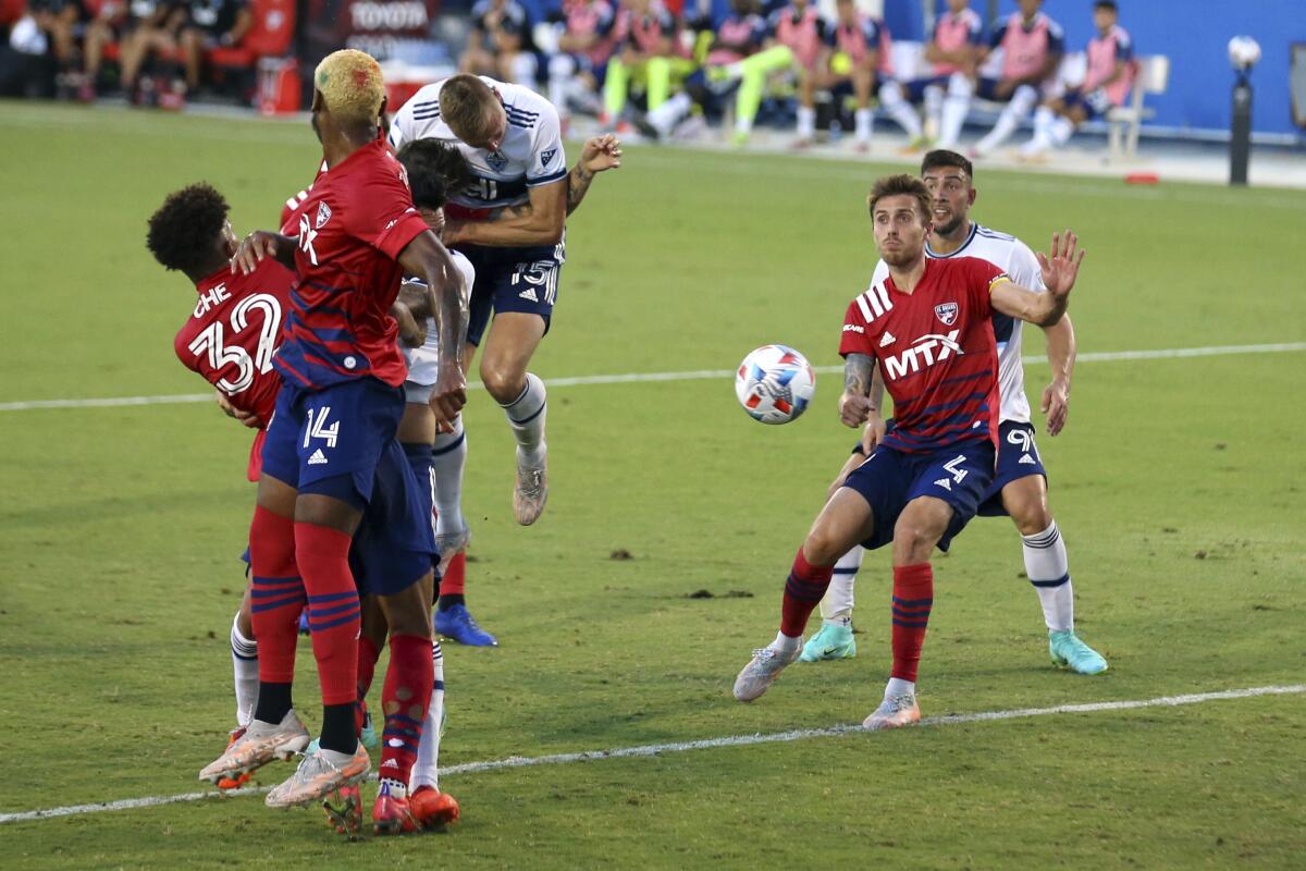 Vancouver Whitecaps midfielder Andy Rose (15) heads the ball toward the goal after a corner kick in the first half against FC Dallas in an MLS match, Sunday, July 4, 2021, in Frisco, Texas. (AP Photo/Richard W. Rodriguez)
