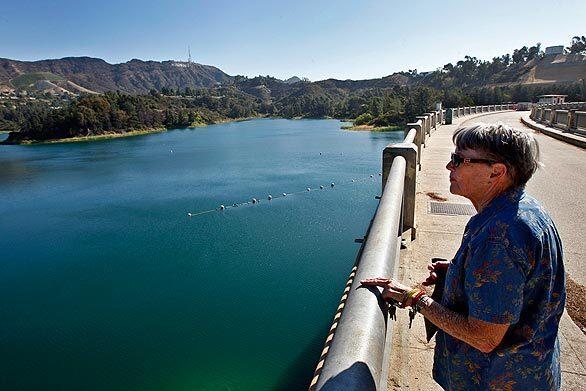 Mary Lane of Hollywood takes in the view on her first walk around the Lake Hollywood Reservoir in more than four years. Los Angeles Councilman Tom LaBonge and Department of Water and Power officials reopen the eastern perimeter road, which was closed by landslides during the record-breaking rainstorms in 2005.