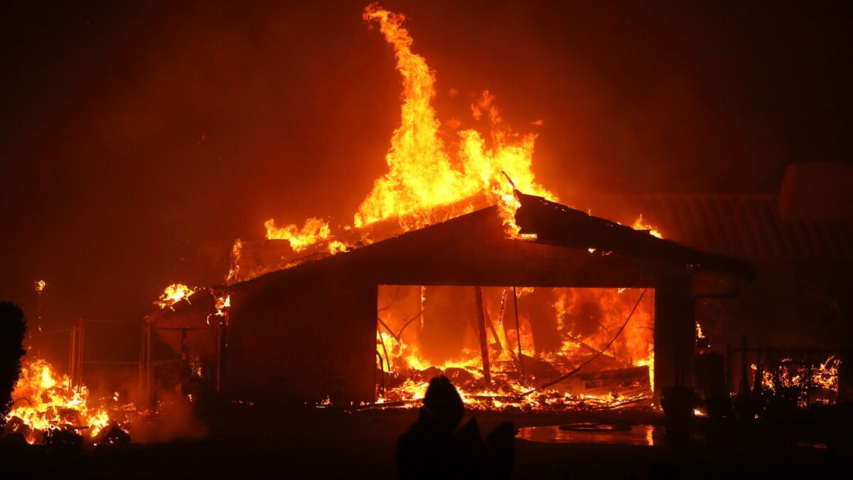 A home is consumed by the Woolsey fire along Pacific Coast Highway in Malibu.