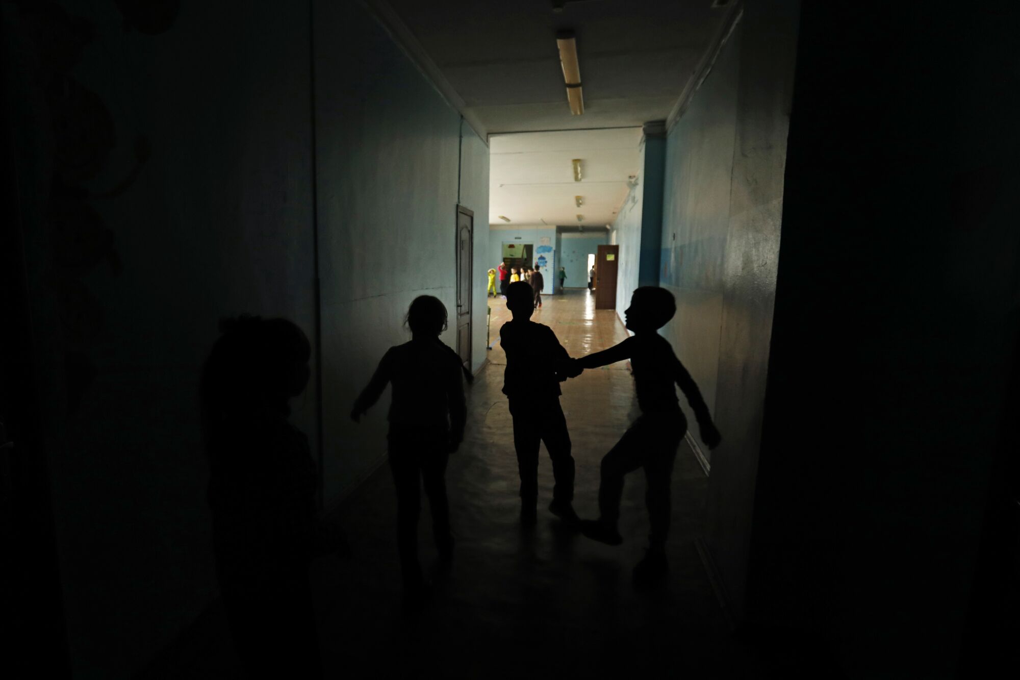 Children play in a dark corridor 