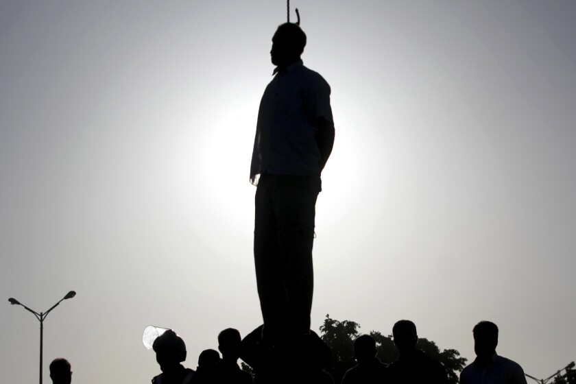 The silhouette of an executed Iranian convict in Qazvin, 80 miles west of Tehran.