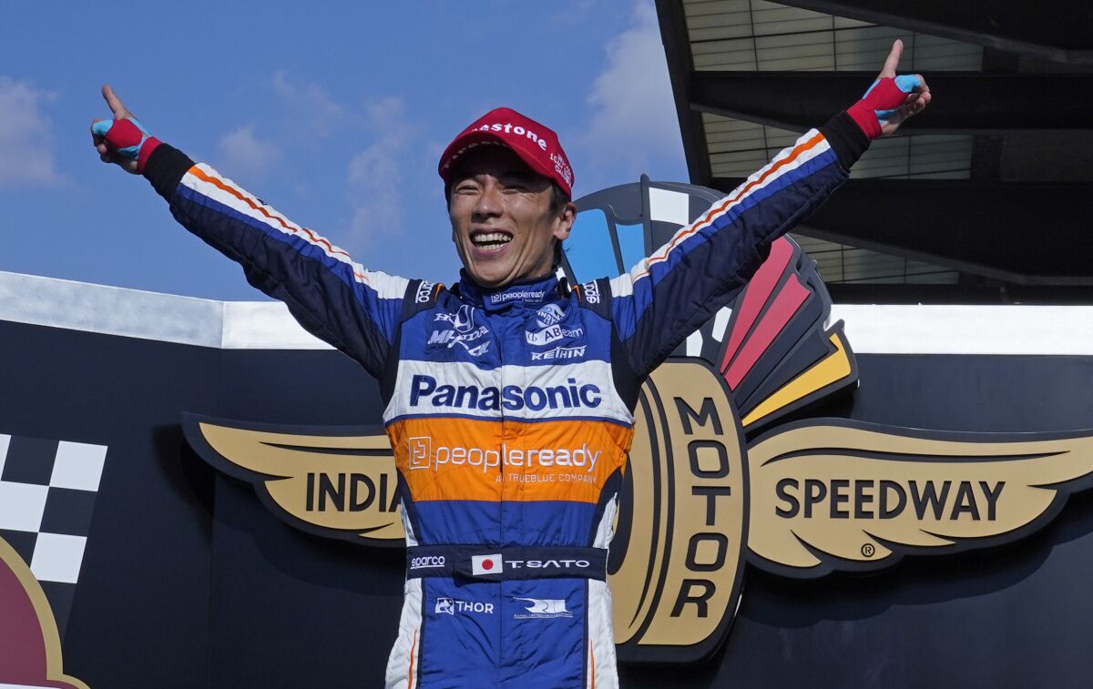 Takuma Sato celebrates after winning the Indianapolis 500 on Sunday for the second time.