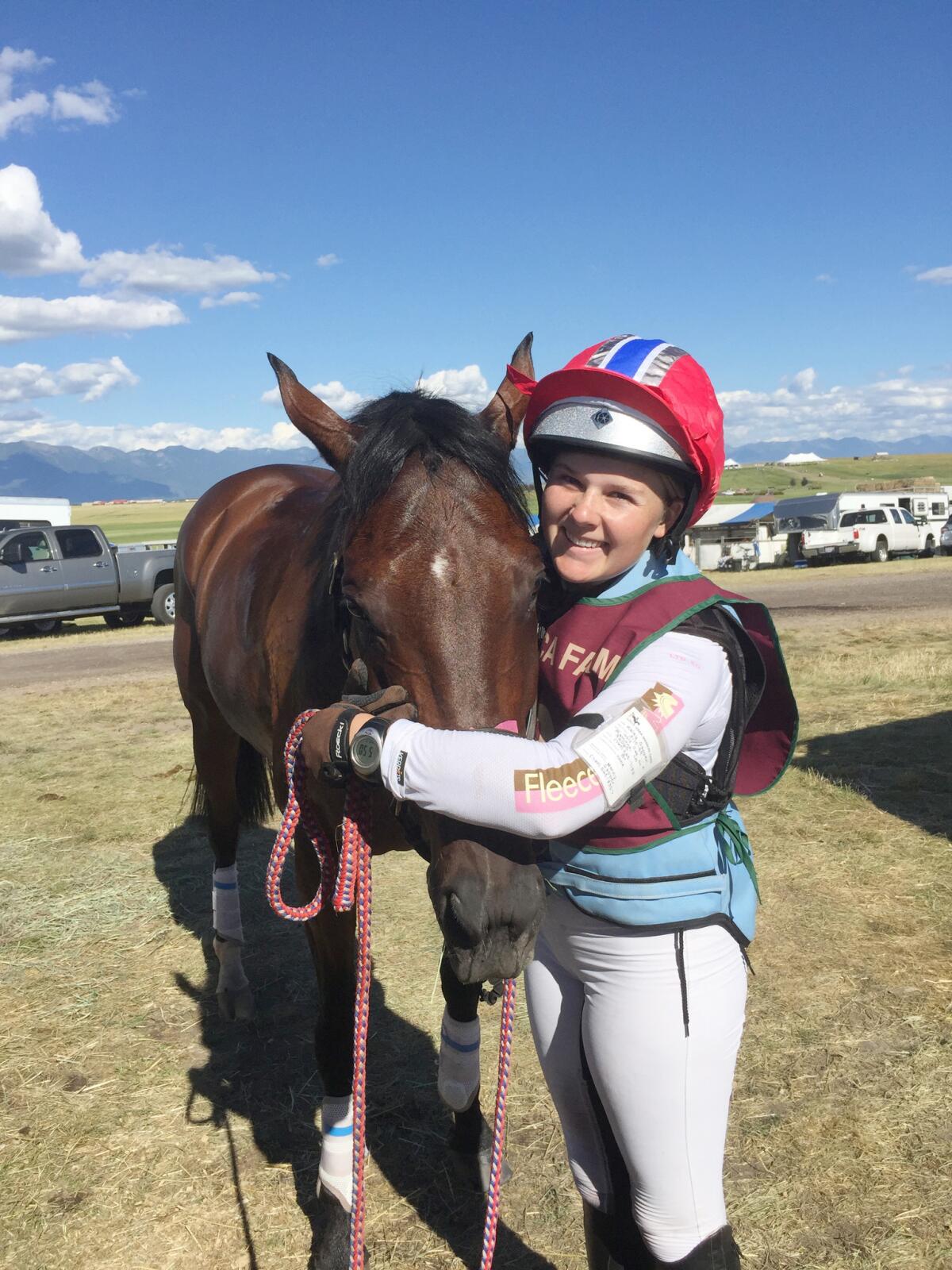 Kaley Sapper hugs Tuk after they complete a clean cross-country run in the optimum time. (Courtesy photo)