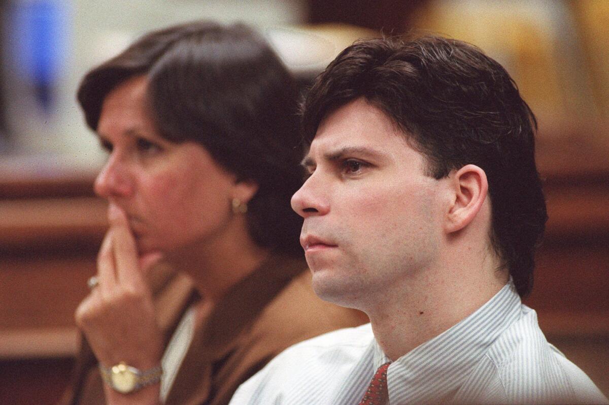 Lyle Menendez listens to the defense's closing arguments in the murder retrial of him and his brother, Eric, in a Van Nuys courthouse in Los Angeles on Feb. 29, 1996. At left is Lyle Menendez's attorney Terri Towery.