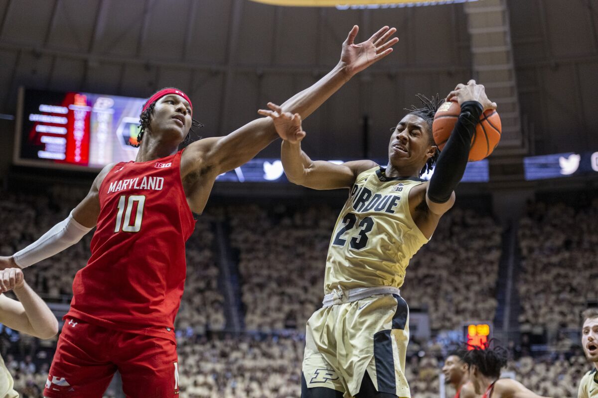 Purdue guard Jaden Ivey (23) reacts as he catches a rebound while Maryland forward Julian Reese (10) defends during the first half of an NCAA college basketball game, Sunday, Feb. 13, 2022, in West Lafayette, Ind. (AP Photo/Doug McSchooler)