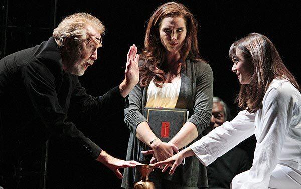 Burke Dennings (Harry Groener), director of actress Chris MacNeil's (Brooke Shields) latest, tries to help the possessed Regan MacNeil (Emily Yetter) in "The Exorcist" at Geffen Playhouse.
