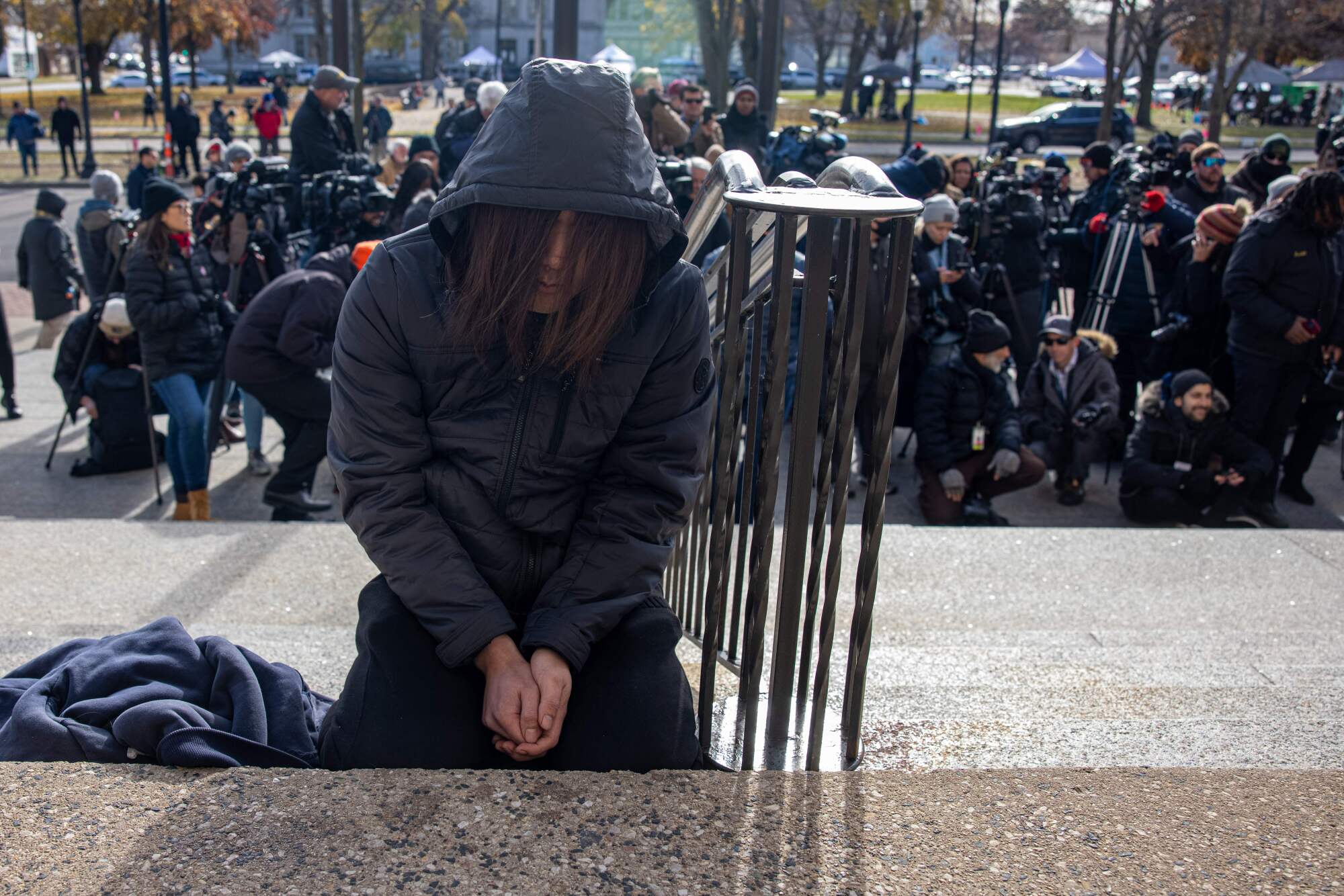 A woman prays outside court in Kenosha.