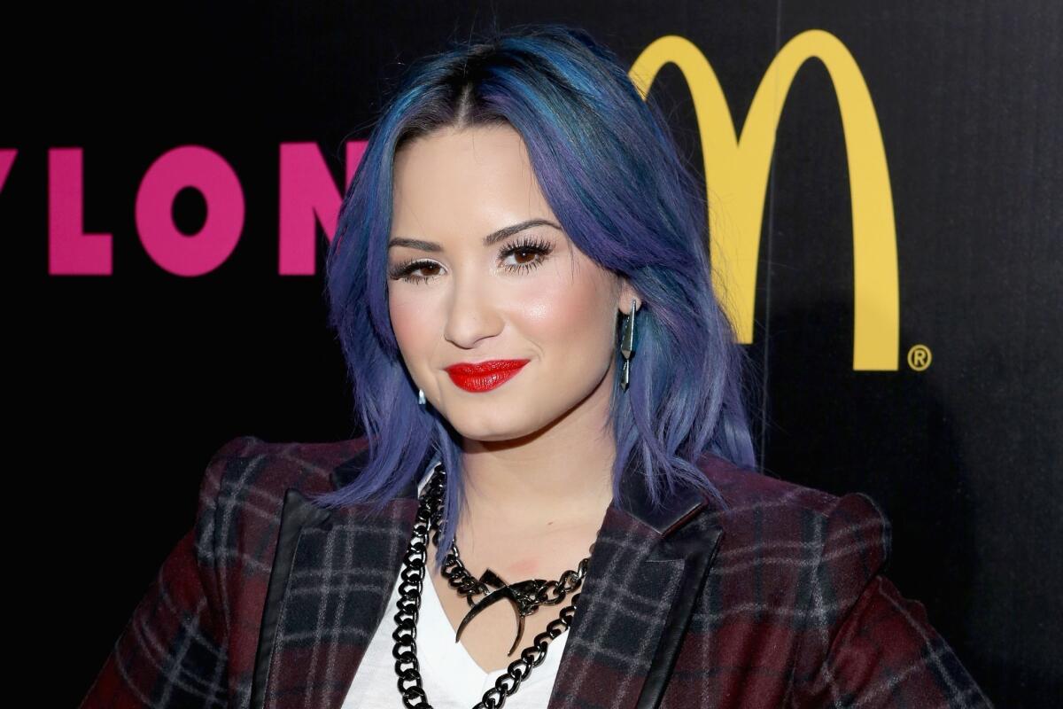 Demi Lovato said she hit bottom when she was on the way to the airport at 9 a.m. with a Sprite bottle filled with vodka, headed back to a sober-living facility she was staying at and throwing up in the car. She said she realized that was alcoholic behavior.
