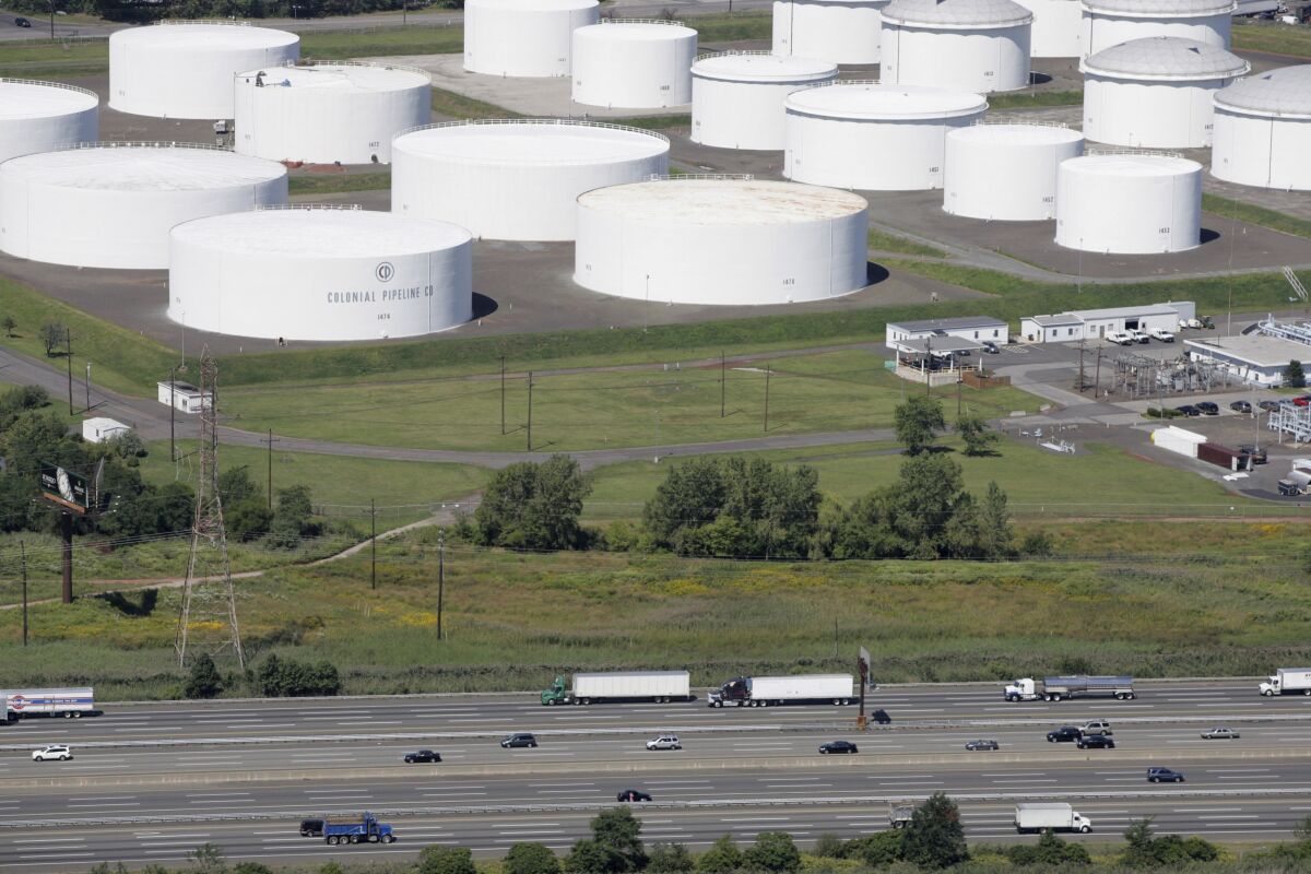 Traffic on I-95 passes oil storage tanks owned by the Colonial Pipeline Company in Linden, N.J. 