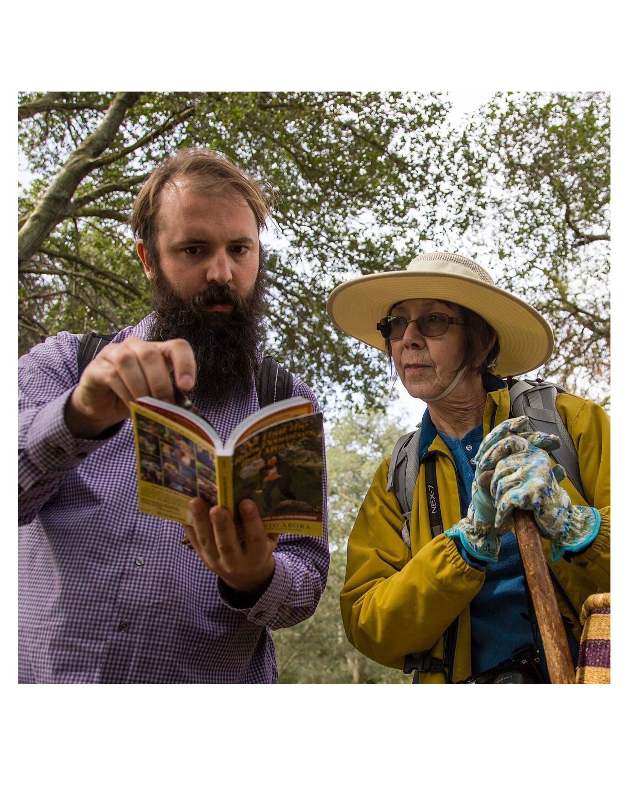 Los Angeles Mycological Society members look at a book