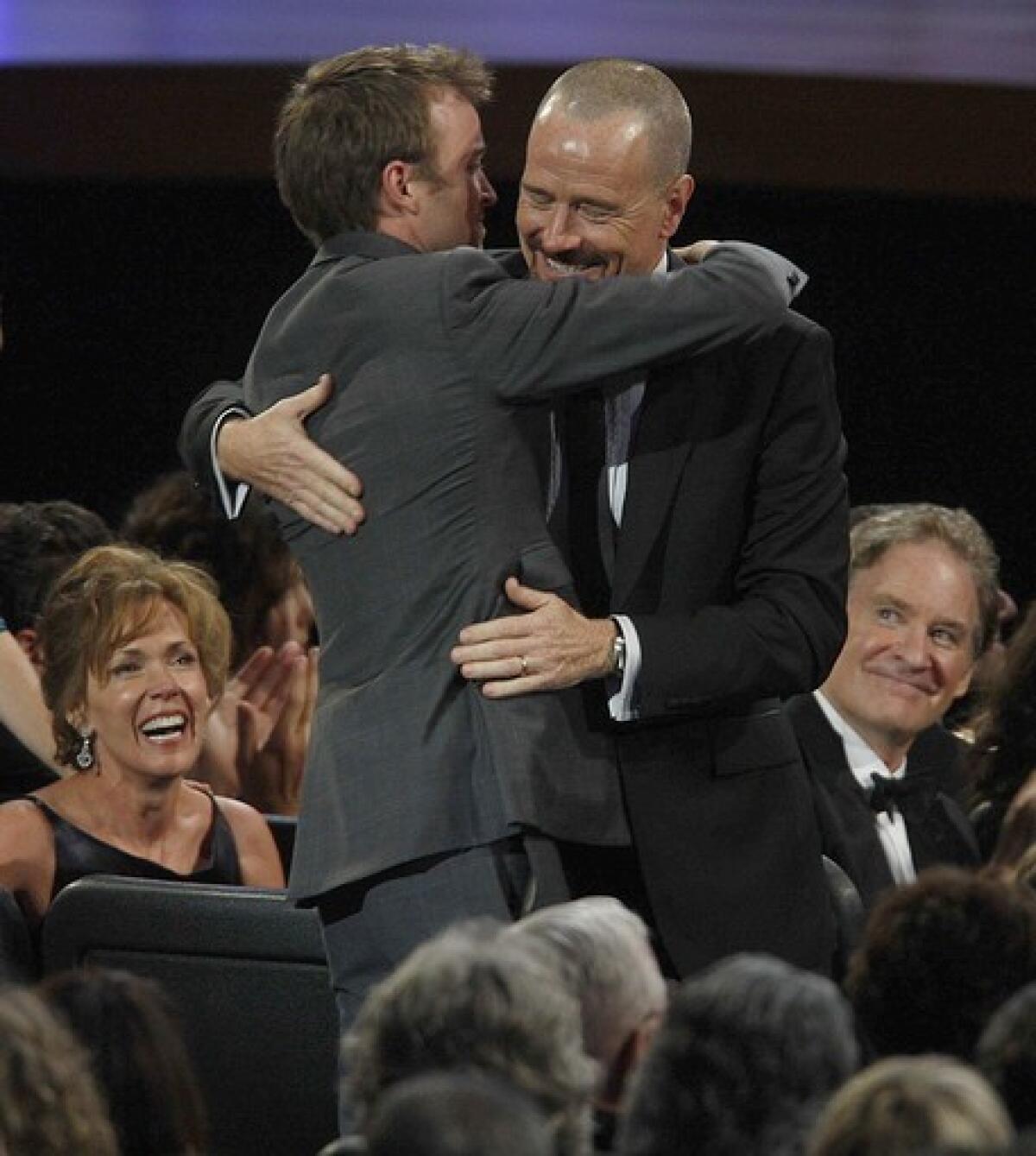 Bryan Cranston gets a hug from "Breaking Bad" costar Aaron Paul. In his speech after winning for outstanding lead actor in a drama series, Cranston gave a nod to his Valley roots.