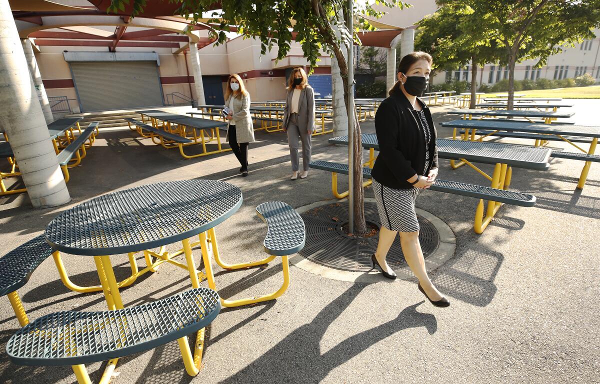 Perla Chavez-Fritz, foreground, principal of Cerritos Elementary in Glendale, looks over an outdoor lunch eating area.