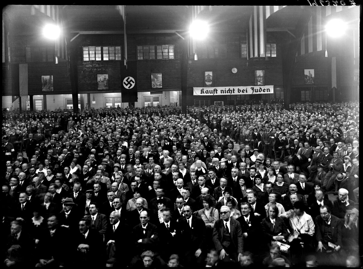 Nazi Party political rally. Sign in the back reads, "Don't buy from Jews." circa 1919-34