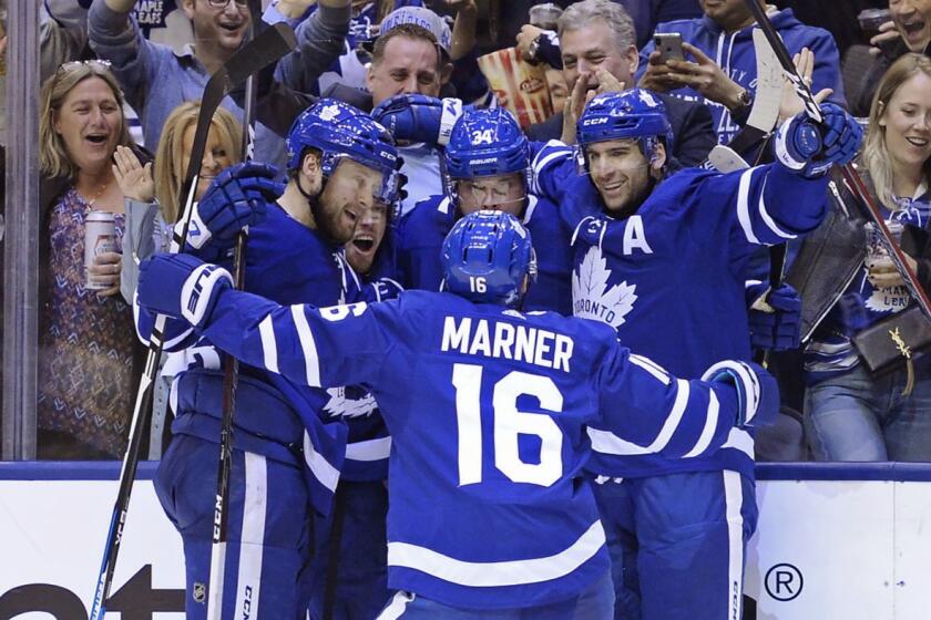 Toronto Maple Leafs center Auston Matthews (34) celebrates his goal against the Boston Bruins with teammates during the second period of an NHL playoff hockey game in Toronto on Monday, April 15, 2019. (Nathan Denette/The Canadian Press via AP)