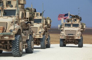 An American military convoy stops near the town of Tel Tamr, Syria, on Sunday.