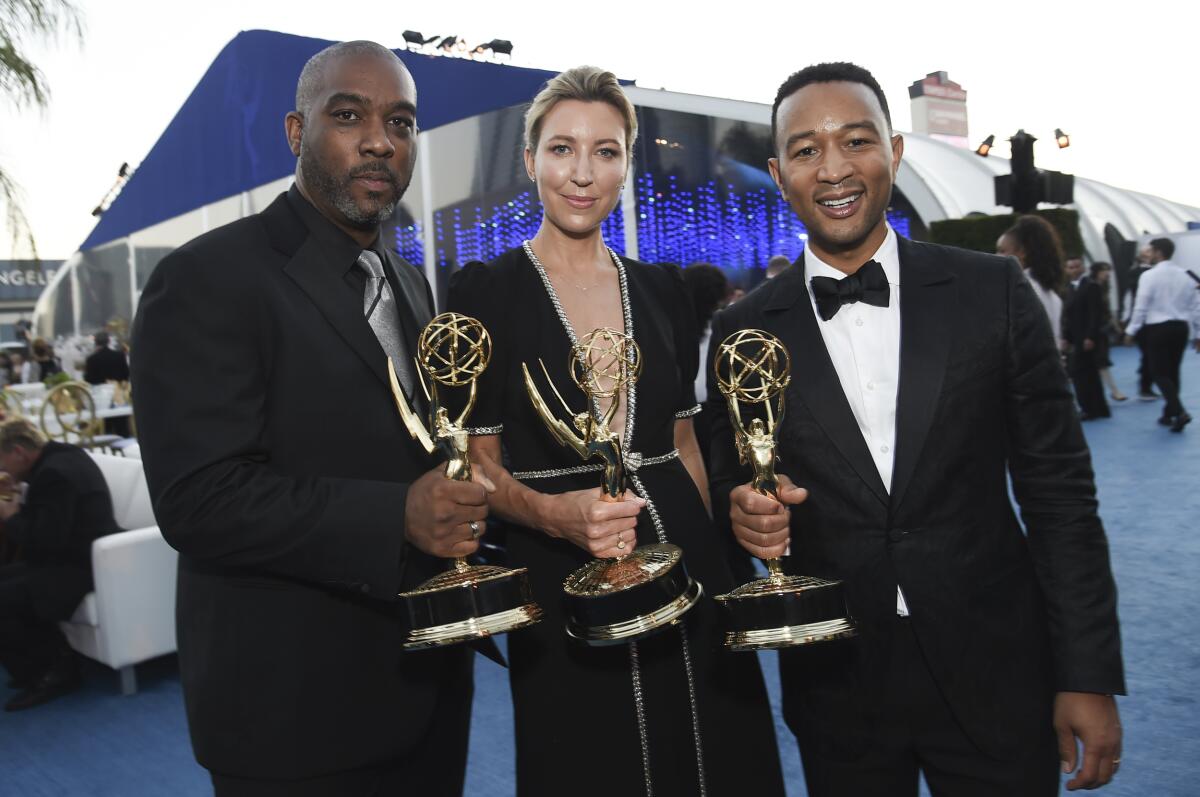 Mike Jackson, from left, Ty Stiklorius, and John Legend attend the Governors Ball during the 2018 Creative Arts Emmy Awards.