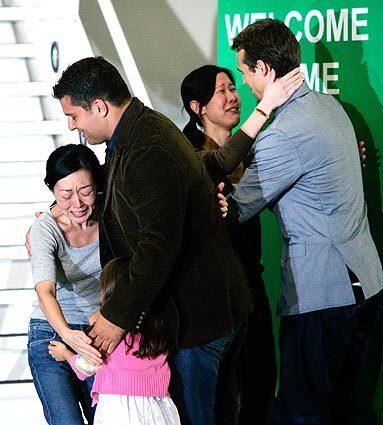 TV journalists Euna Lee, left, and Laura Ling arrive at Bob Hope Airport in Burbank upon returning from custody in North Korea. Lee is greeted by husband Michael Seldate and 4-year-old daughter Hana, and Ling by husband Iain Clayton.