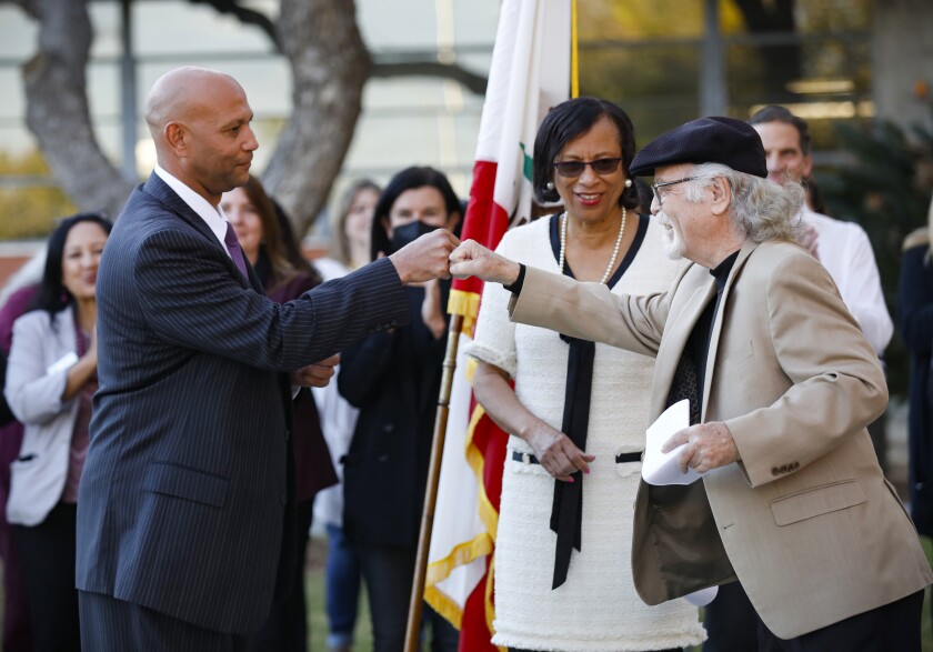 San Diego Unified School District board member Michael McQuary (right) fist bumps Dr. Lamont Jackson.