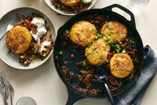 Biscuit-topped turkey chili in a cast-iron skillet.