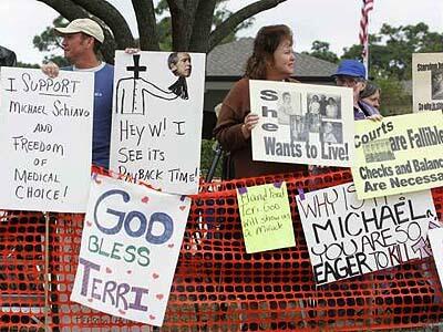 People concerned about the outcome of the Terri Schiavo case gather outside Woodside Hospice in Pinellas Park, Fla., where the brain-damaged woman is being cared for.