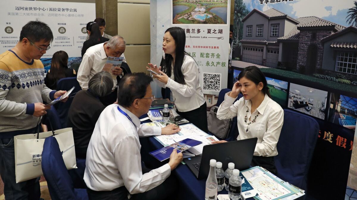 Chinese visitors seek information about the U.S. government's EB-5 visa program at an Invest in America Summit in Beijing on May 7, 2017.