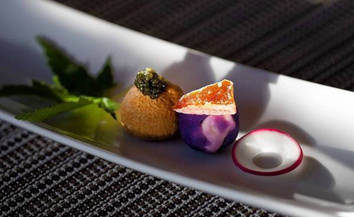 Purple potato and blue cheese, ankimo (monk fish liver) with caviar and dried persimmon on top is served at Shunji Japanese Cuisine in Los Angeles.