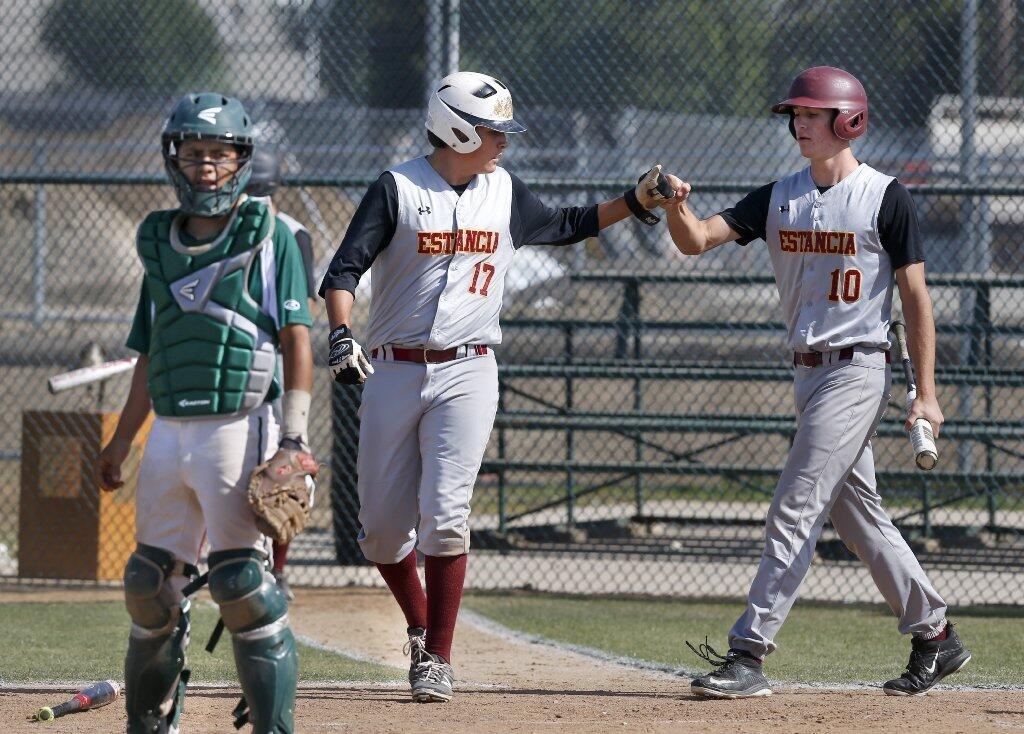 Estancia High's Brian Rodriguez and Jake McIntyre celebrate a run.