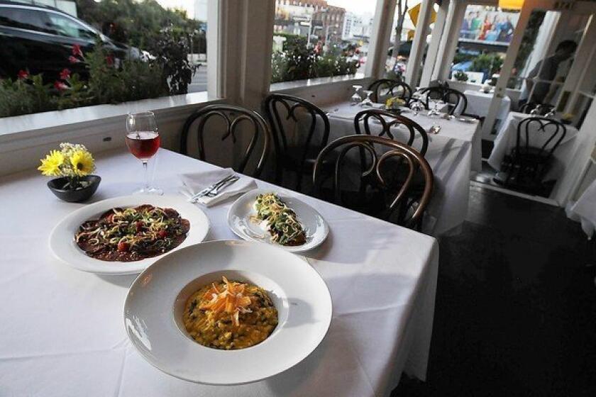 Risotto carote e bietola is-carrot puree, chard and oregano (foreground), barbabietole con burrata is made with baby beets, burrata, pistachios and white balsamic dressing, right, and carpaccio di capriolo isvenison carpaccio, white anchovies and raspberries.